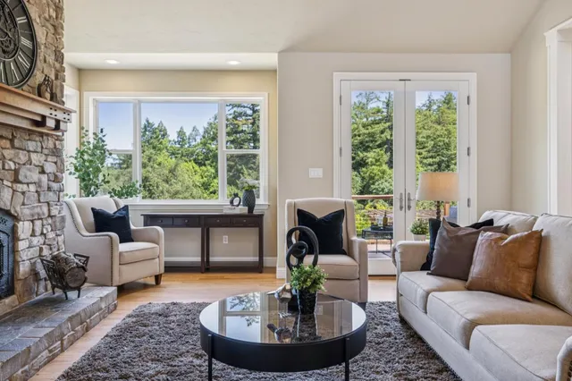 a living room with furniture and a floor to ceiling window