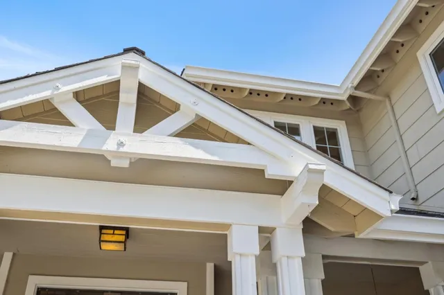 a dining room with furniture a large window and a rug