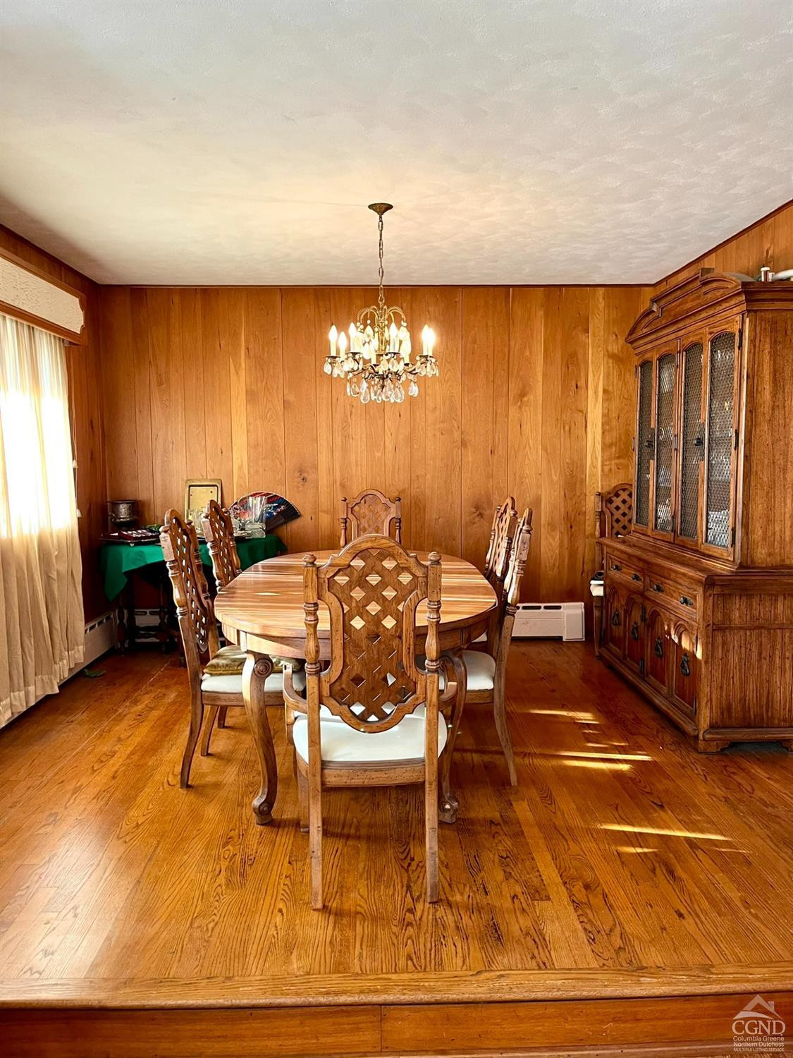 375 Church Road Hudson, NY 12534 - Photo 9 of 15 a dining room with furniture a chandelier a rug and a large window
