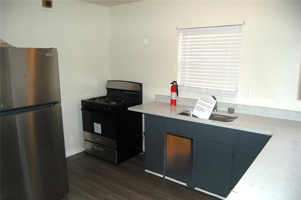 856 Beckwith Street Southwest Atlanta, GA 30314 - Photo 15 of 19 a kitchen with a sink cabinets and wooden floor