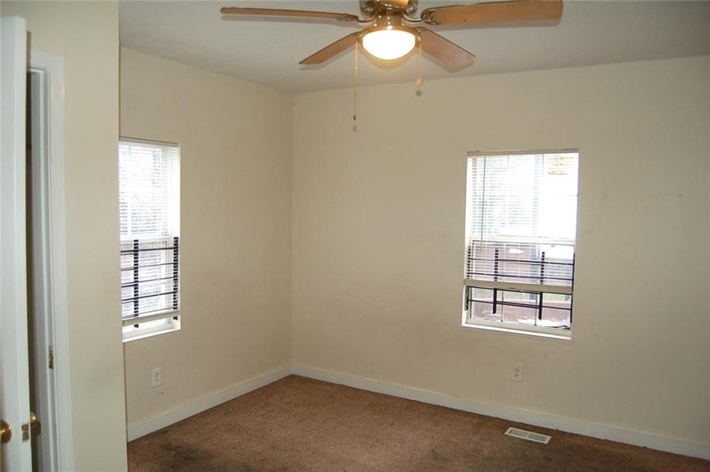856 Beckwith Street Southwest Atlanta, GA 30314 - Photo 19 of 19 an empty room with windows and chandelier fan