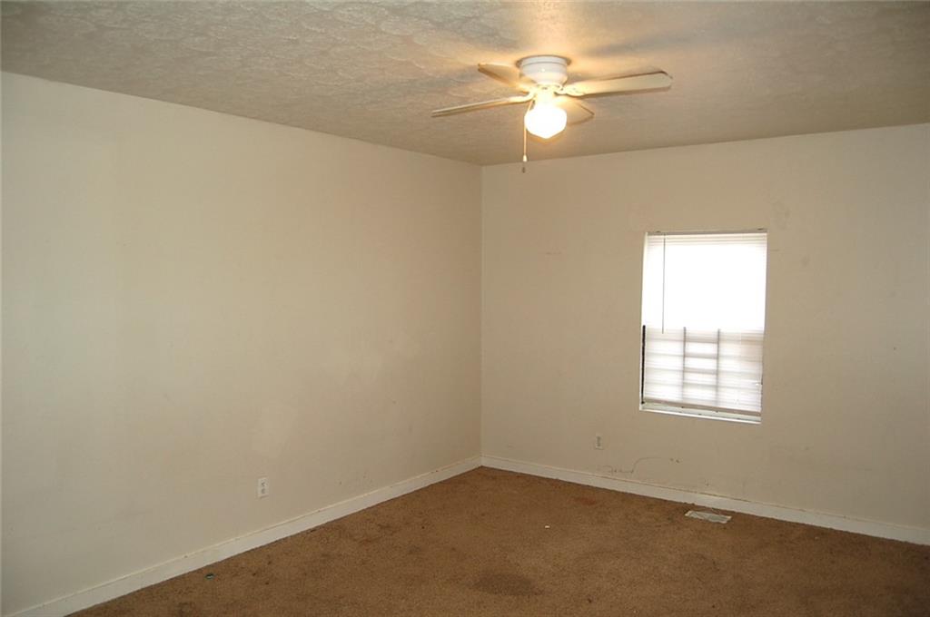 856 Beckwith Street Southwest Atlanta, GA 30314 - Photo 10 of 19 an empty room with windows and fan