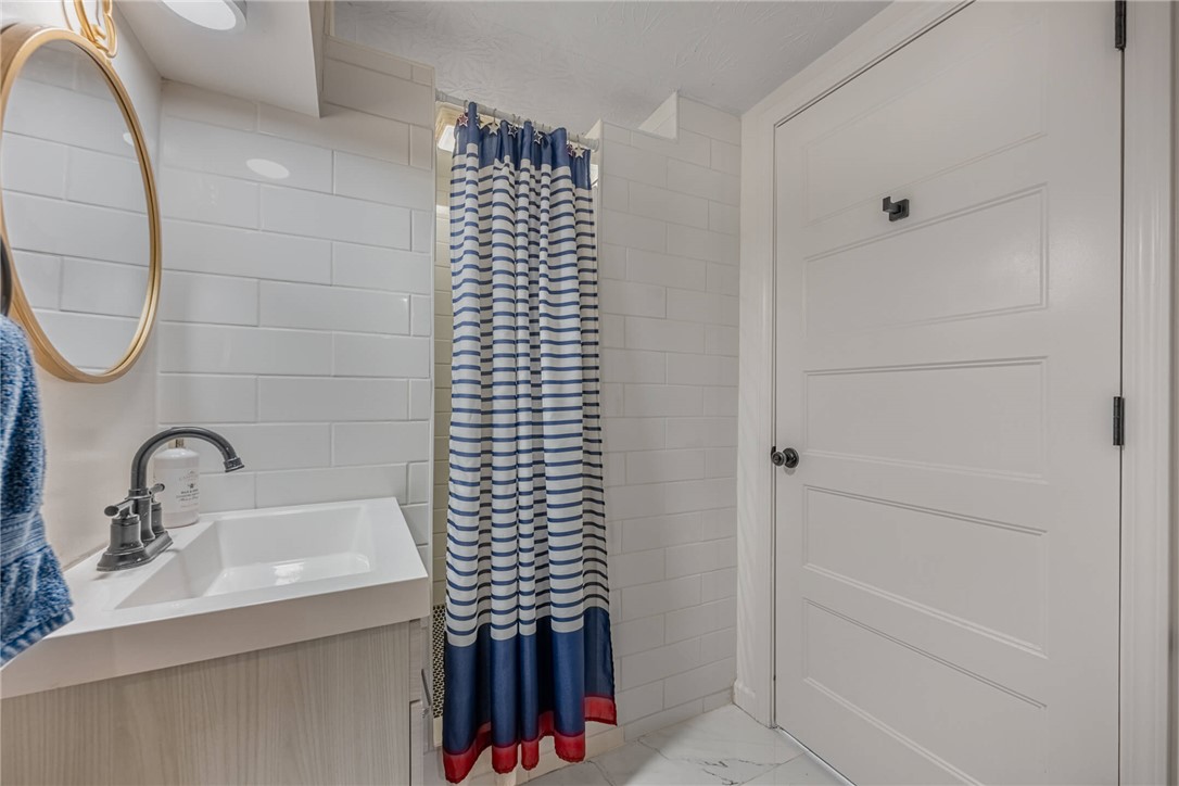 436 Marjorie Avenue Riverside, OH 45404 - Photo 25 of 34 This bright bathroom features subway tile, a sleek vanity, and a refreshing shower space.