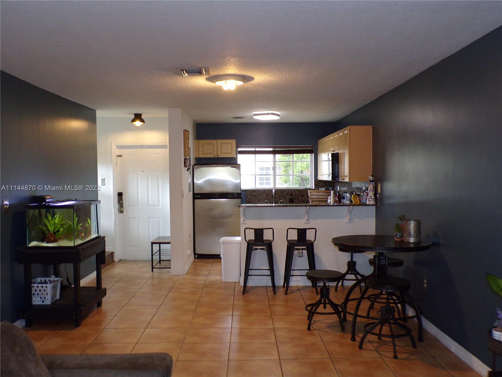a kitchen with a sink cabinets and dining table