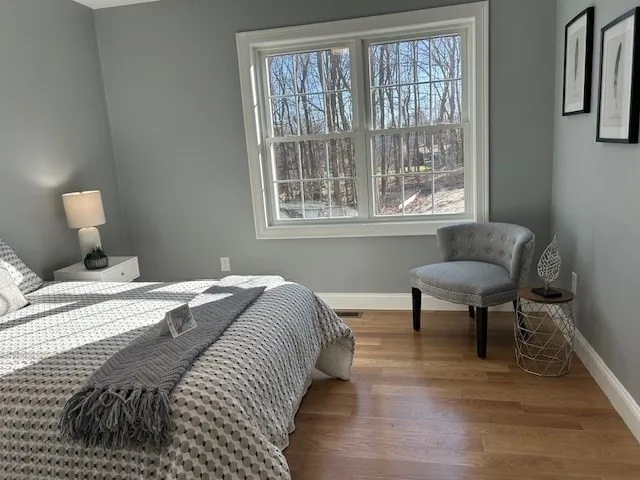 a bedroom with a bed and a chair