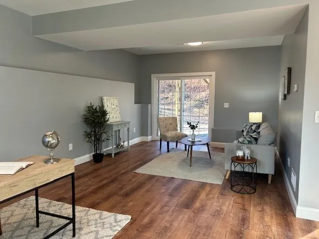 a living room with furniture and a potted plant