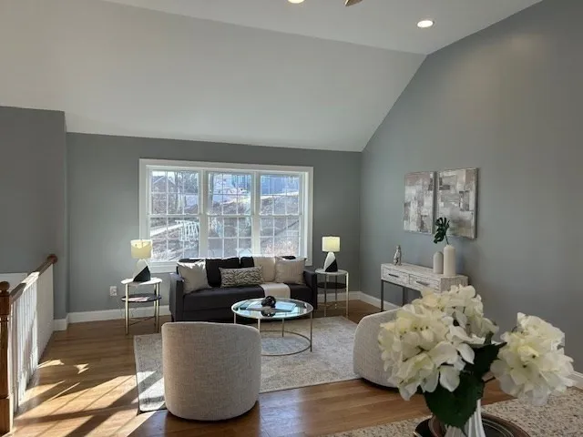 a living room with furniture and wooden floor