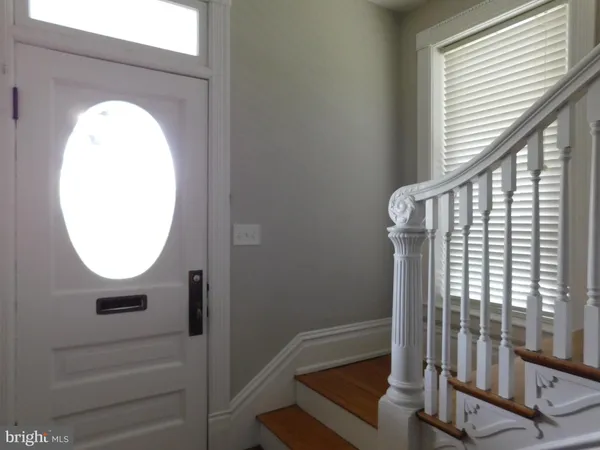 an entryway view with wooden floor and windows
