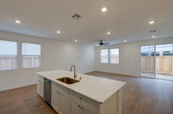 a kitchen with a sink a counter space and stainless steel appliances