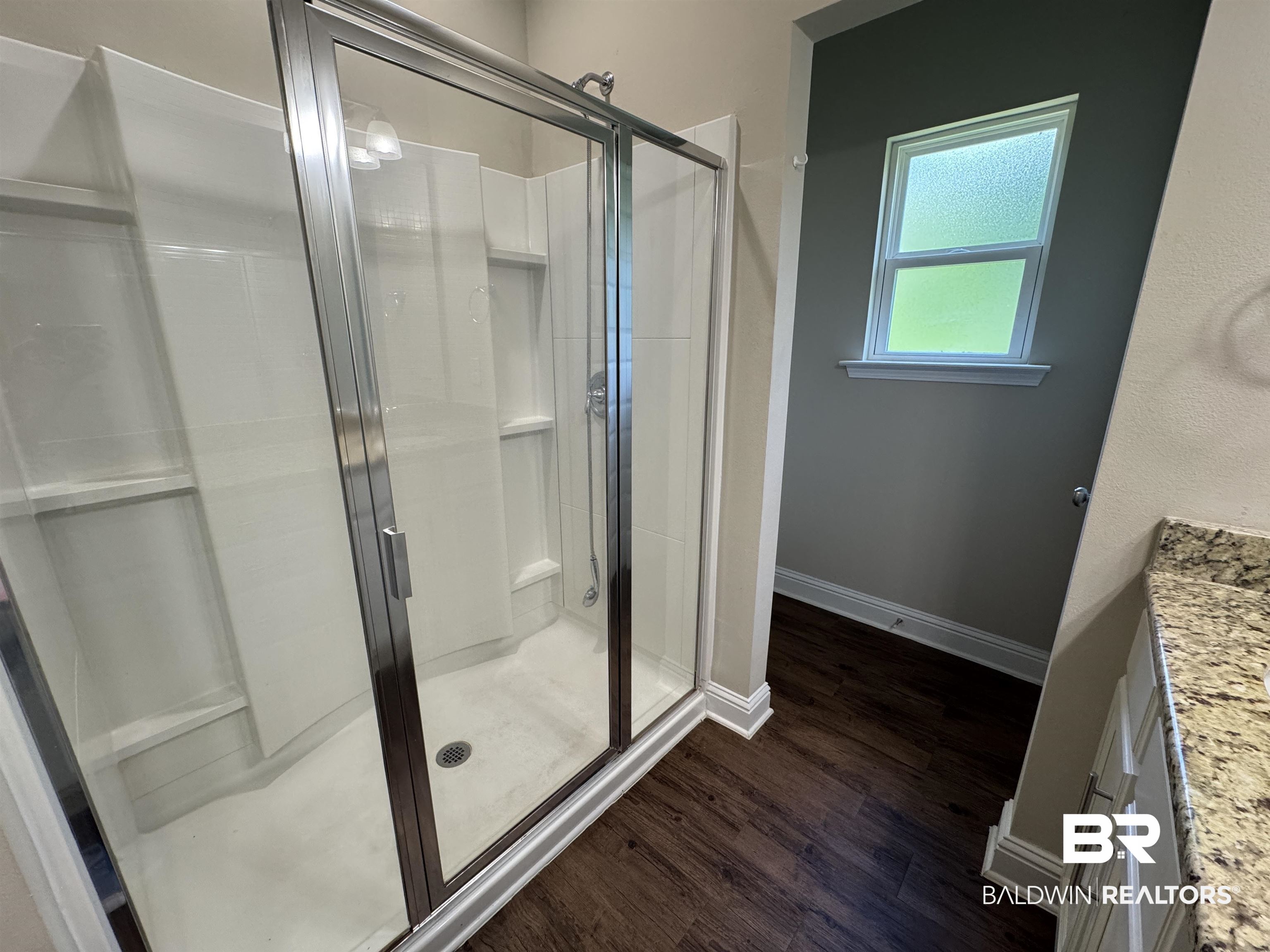 6811 Spaniel Drive, Unit C Daphne, AL 36527 - Photo 16 of 33 Full bathroom with a stall shower, vanity, wood finished floors, and baseboards