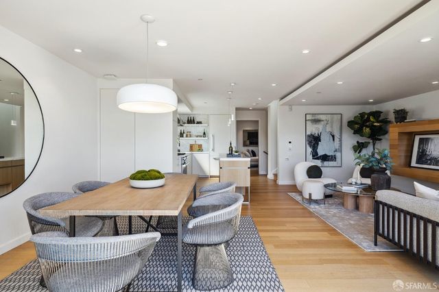 a living room with furniture a mirror and a table