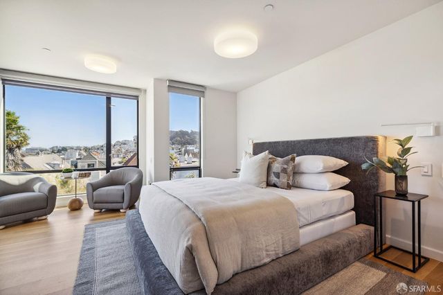 a bedroom with double bed and a couch