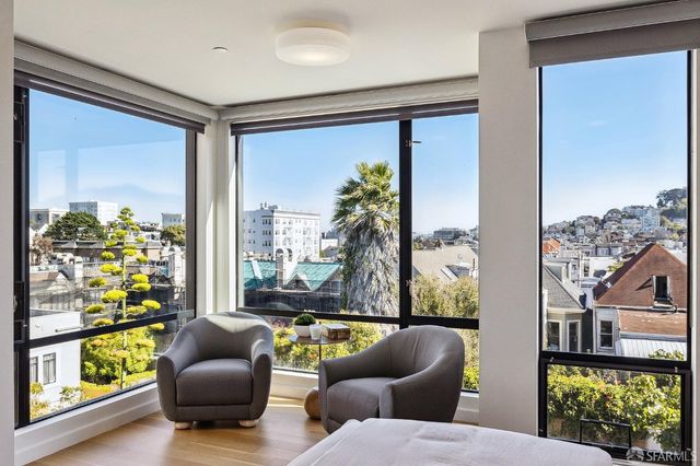 a living room with furniture and a floor to ceiling window