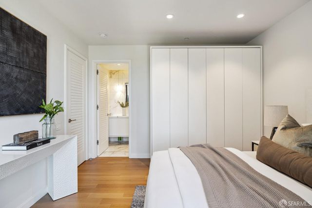 a bedroom with a bed and a potted plant