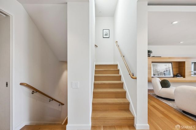 a view of entryway and hall with wooden floor