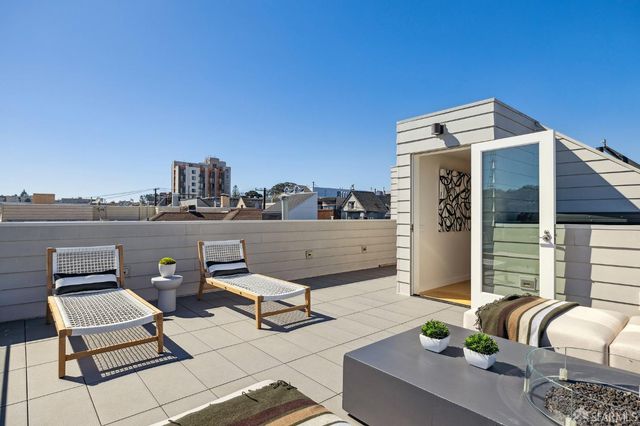 a terrace of a house with outdoor seating