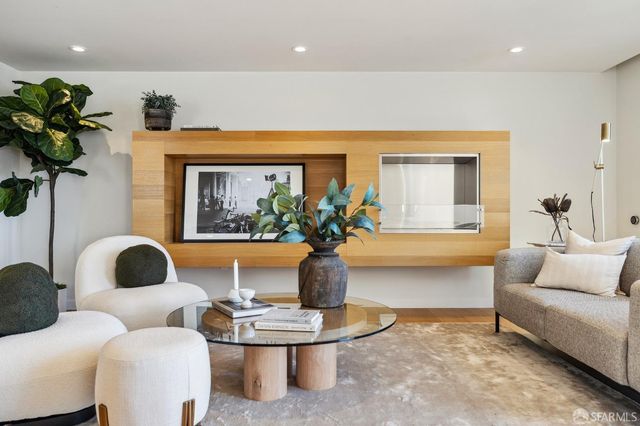 a living room with furniture and a potted plant