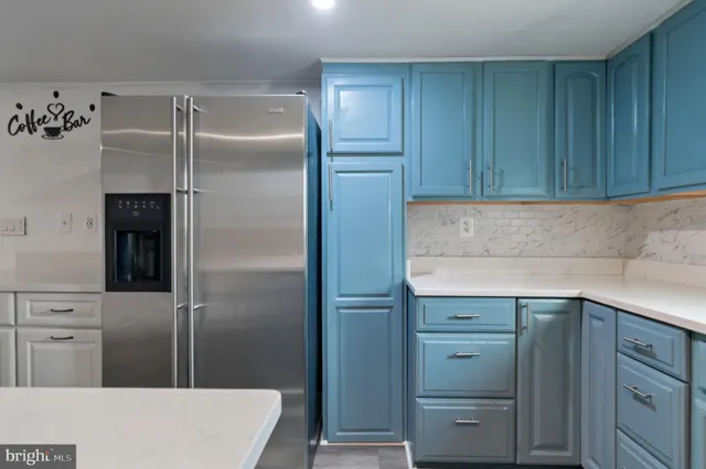 a kitchen with cabinets and stainless steel appliances