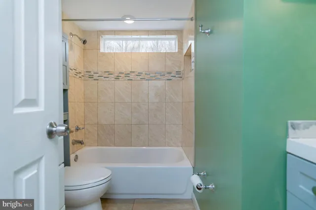 a bathroom with a bathtub a toilet and a shower