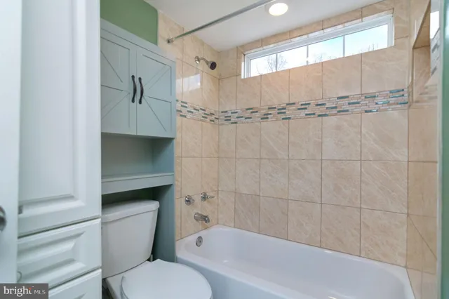 a bathroom with a toilet and a bathtub