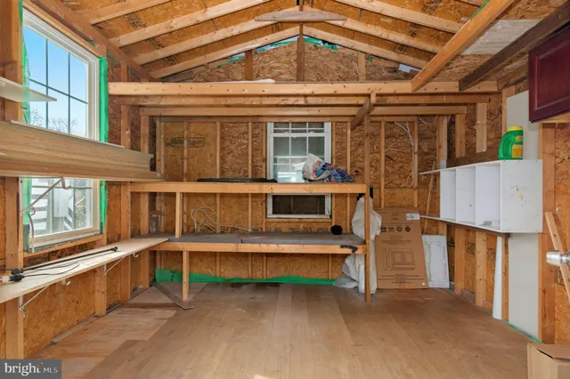 a view of a house with a large window and wooden fence