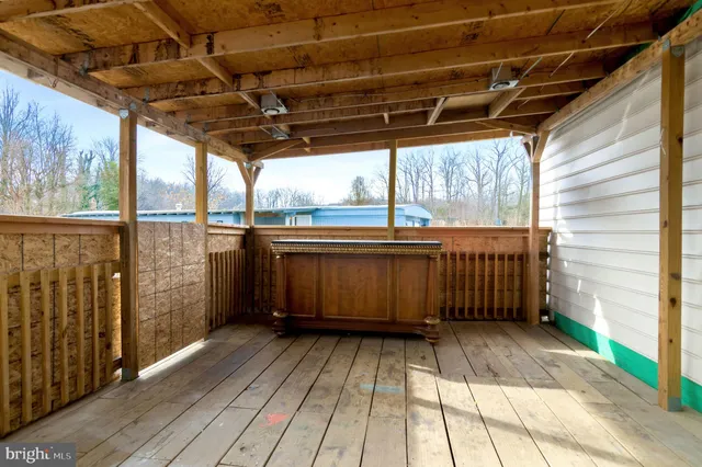 a view of a porch with wooden floor
