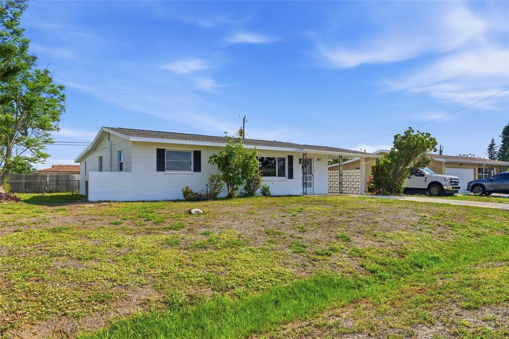 363 Glen Oak Road Venice, FL 34293 - Photo 49 of 53 a front view of house with yard and trees in the background