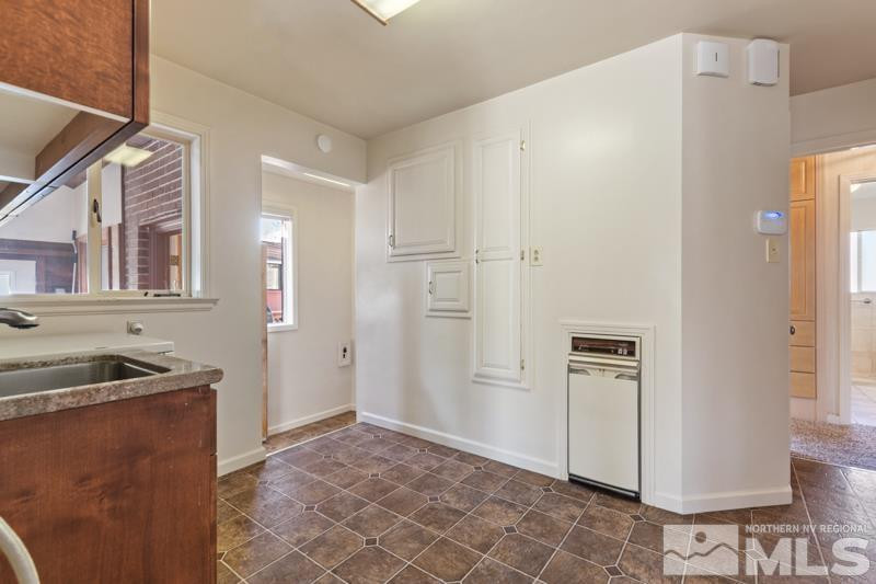 2250 Foothill Road Reno, NV 89511 - Photo 13 of 37 a kitchen with cabinets and a refrigerator