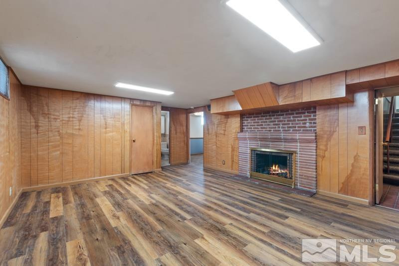2250 Foothill Road Reno, NV 89511 - Photo 21 of 37 a view of an empty room with wooden floor fireplace and a window