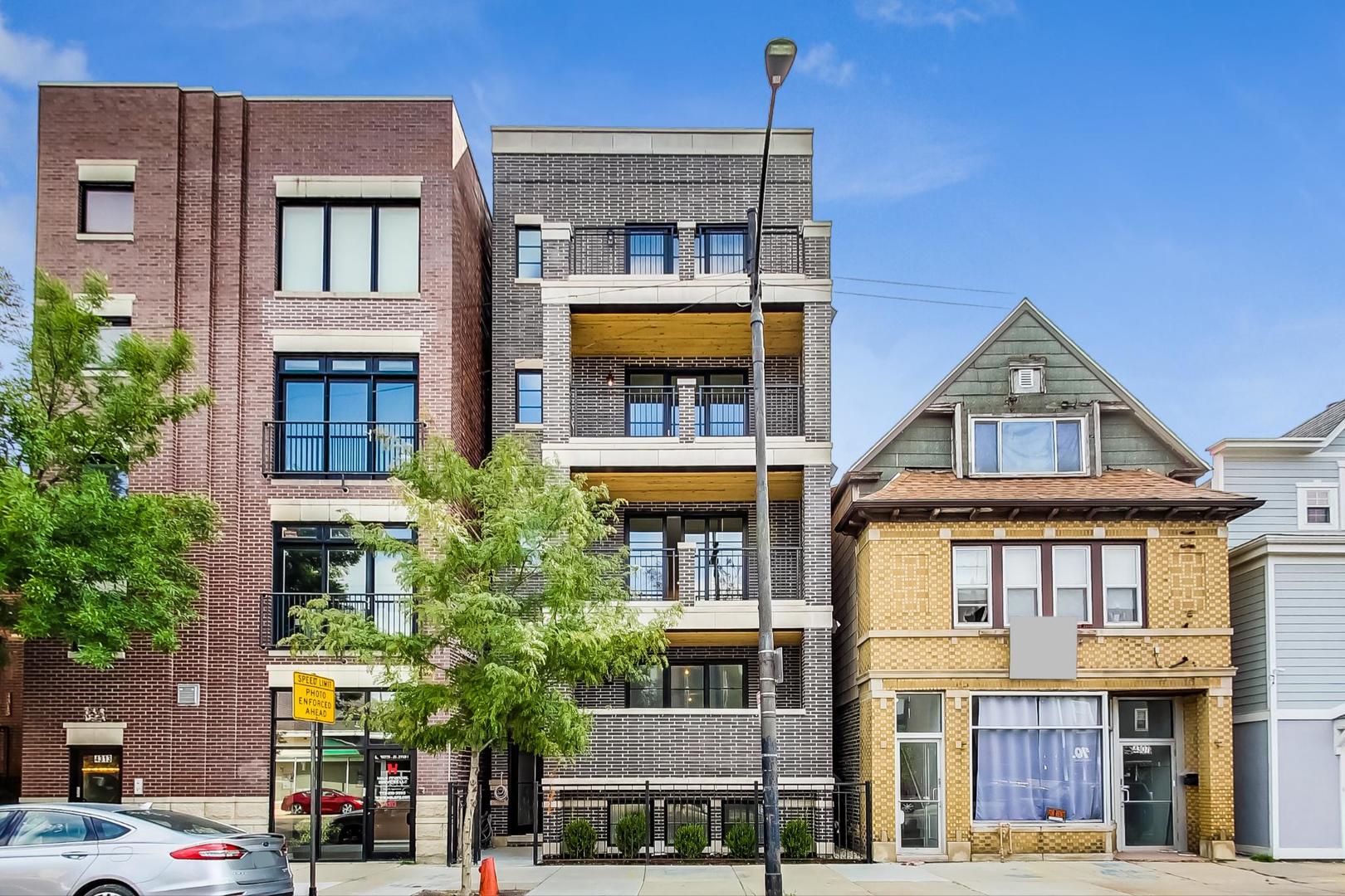 4311 North Western Avenue, Unit 1 Chicago, IL 60618 - Photo 1 of 18 a front view of residential houses with yard