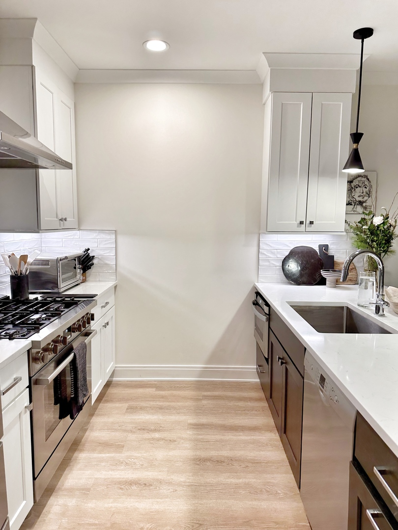 4311 North Western Avenue, Unit 1 Chicago, IL 60618 - Photo 4 of 18 a kitchen with a sink stove top oven and cabinets