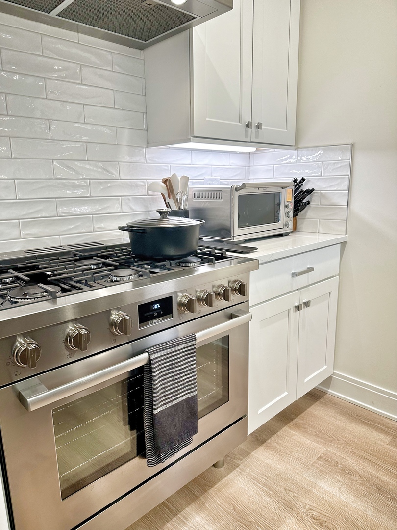 4311 North Western Avenue, Unit 1 Chicago, IL 60618 - Photo 5 of 18 a kitchen with granite countertop white cabinets and appliances