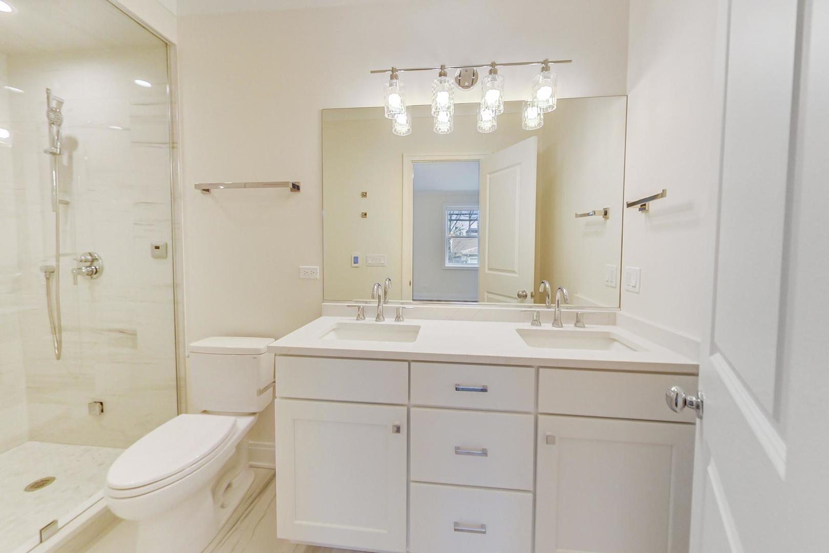 4311 North Western Avenue, Unit 1 Chicago, IL 60618 - Photo 10 of 18 a bathroom with a toilet sink shower and mirror