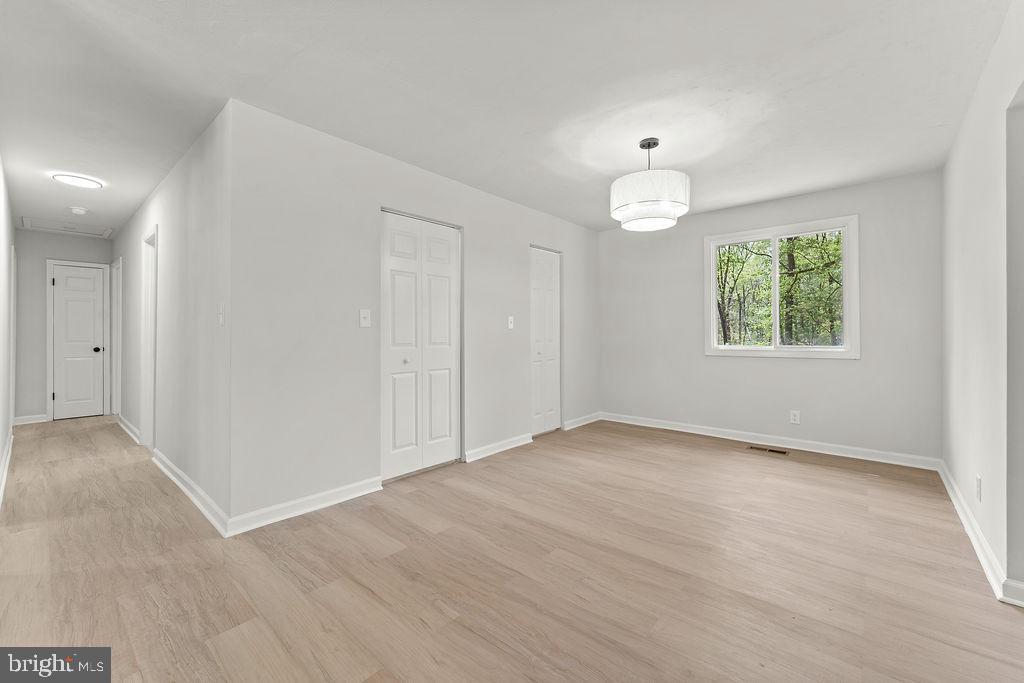 28494 Eddings Road Rhoadesville, VA 22542 - Photo 5 of 32 wooden floor in an empty room with a window