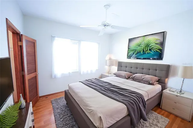 a bedroom with a bed and a chandelier