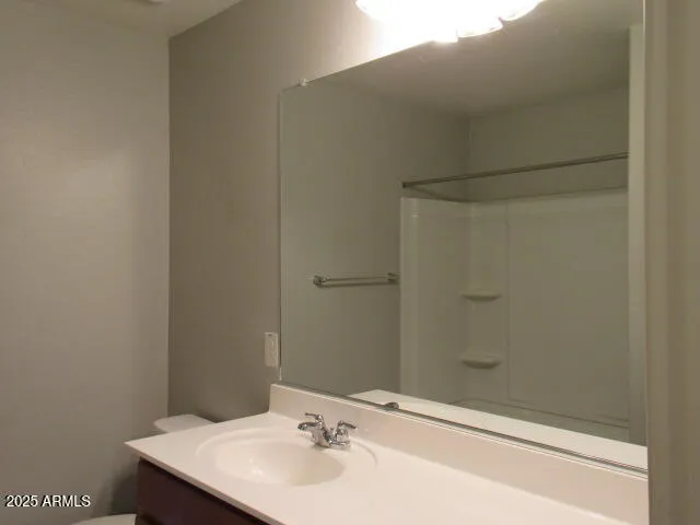 a view of kitchen with stainless steel appliances granite countertop a refrigerator and a stove top oven