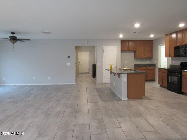 17164 West Straight Arrow Lane Surprise, AZ 85387 - Photo 16 of 39 a view of kitchen with stainless steel appliances granite countertop a refrigerator and a stove top oven