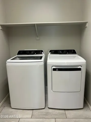 a bathroom with a sink double vanity granite tub shower and a mirror