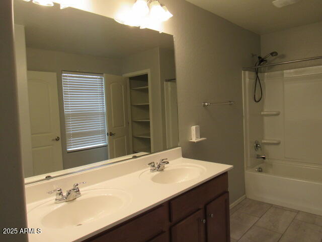17164 West Straight Arrow Lane Surprise, AZ 85387 - Photo 33 of 39 a bathroom with a sink double vanity granite tub shower and a mirror