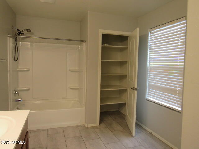 17164 West Straight Arrow Lane Surprise, AZ 85387 - Photo 35 of 39 a bathroom with a bathtub and a shower