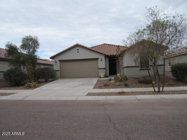 17164 West Straight Arrow Lane Surprise, AZ 85387 - Photo 37 of 39 a front view of a house with a yard and garage