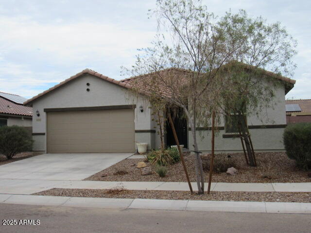 17164 West Straight Arrow Lane Surprise, AZ 85387 - Photo 8 of 39 a front view of a house with a yard