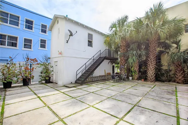 a view of a house with potted plants