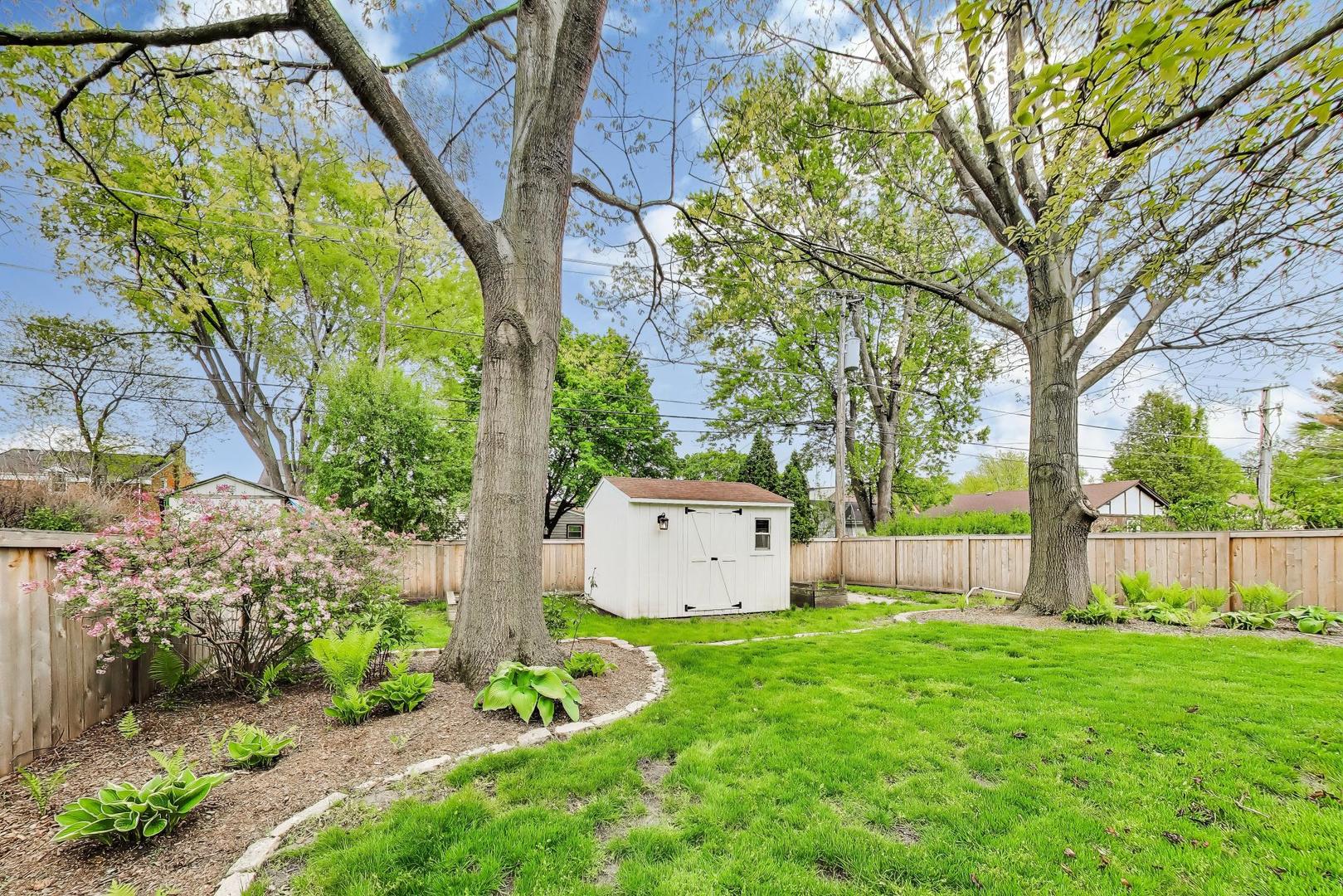 313 South Hi Lusi Avenue Mount Prospect, IL 60056 - Photo 39 of 40 a view of a white house with a big yard and large tree