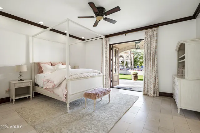 a living room with furniture a fireplace and a chandelier