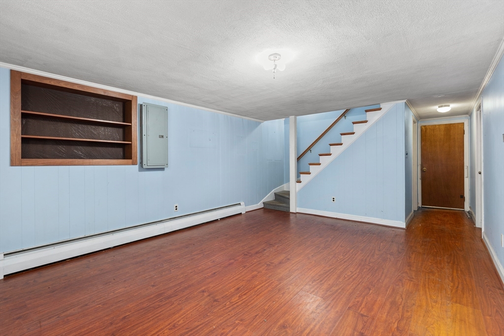 29 Gregory Road Wakefield, MA 01880 - Photo 24 of 29 a view of an empty room with wooden floor and stairs