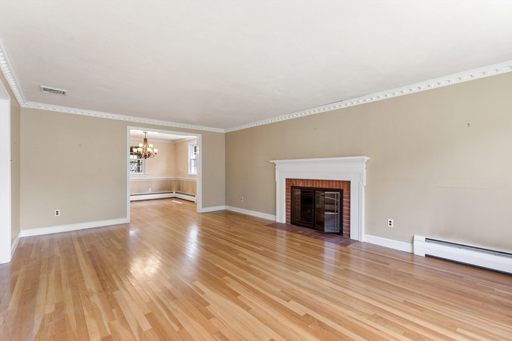 29 Gregory Road Wakefield, MA 01880 - Photo 7 of 29 wooden floor fireplace and natural light in room