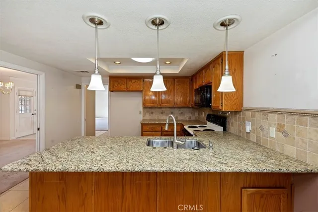 a kitchen with sink window and refrigerator