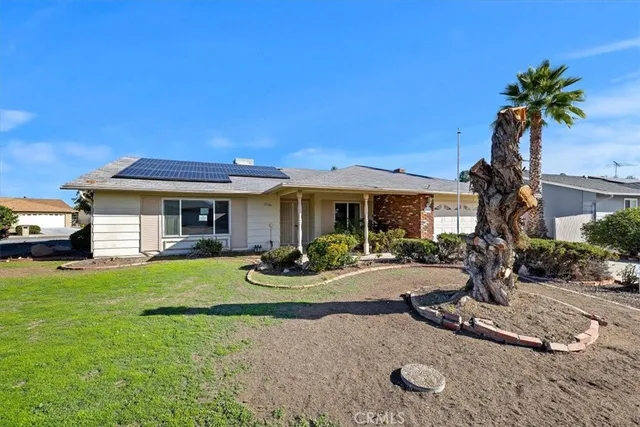 a front view of a house with garden and porch