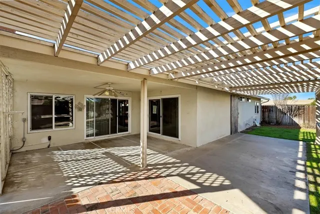 a view of a patio with a table and chairs under an umbrella